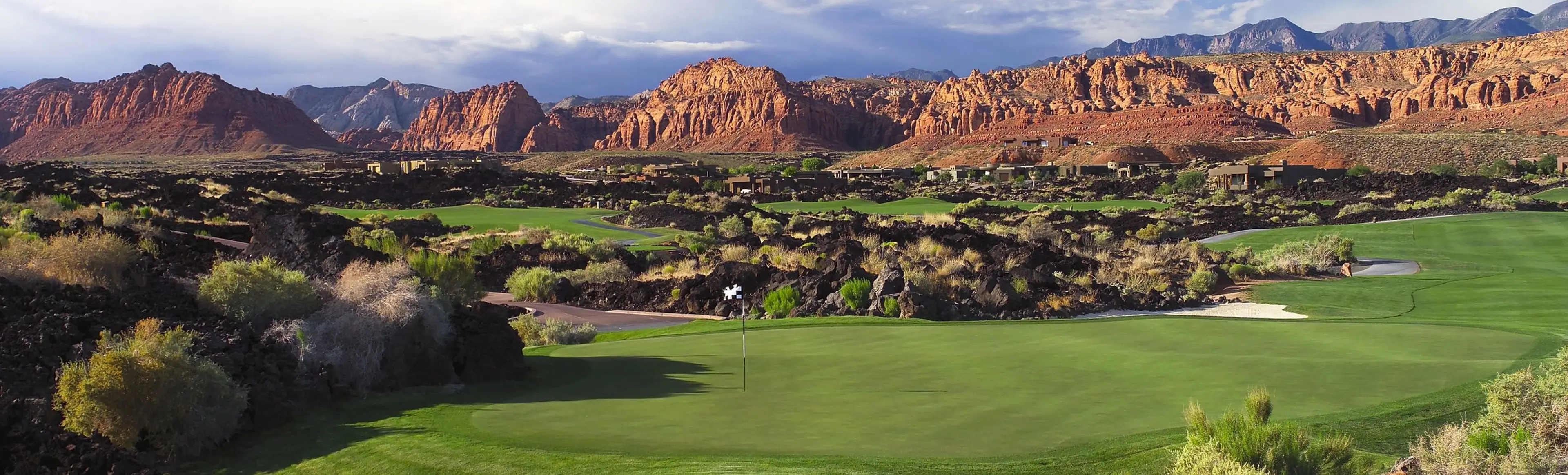 Entrada at Snow Canyon — red and white Navajo sandstone with lava rock features